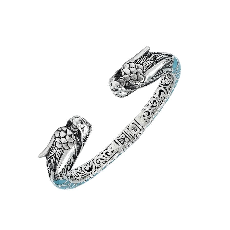 Wholesale sterling silver phoenix bangle featuring Turquoise Shell accents, ornate Balinese scroll engravings, and a secure hinge lock crafted for premium artisan wholesale jewelry collections.