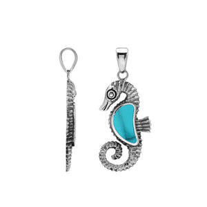 Sterling silver seahorse pendant with turquoise shell inlay and intricate Balinese design featuring a high-gloss polished finish.