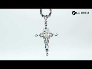 Wholesale sterling silver cross pendant with genuine peridot center stone and blue topaz accents, handcrafted Bali jewelry with ornate detailing for bulk orders.