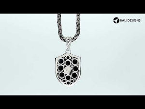 Sterling silver shield-shaped pendant featuring an engraved cross design with textured lattice background and decorative border suitable for classic wholesale jewelry collections