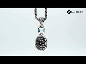 Wholesale sterling silver Blue Topaz pendant with oval and square gemstones, handcrafted Bali filigree design and oxidized finish, artisan jewelry for bulk orders.
