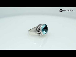 Wholesale sterling silver ring with cushion-cut blue topaz Quartz and Balinese scroll bezel design – handcrafted artisan jewelry from Bali.