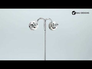 Sterling silver stud earrings with White Pearls and a dotted Balinese border.