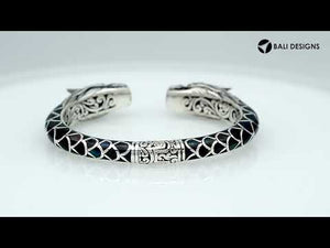 Wholesale sterling silver phoenix bangle featuring Black Shell insets, ornate Balinese scroll carving, and a sturdy hinge lock, crafted for premium artisan wholesale jewelry assortments.