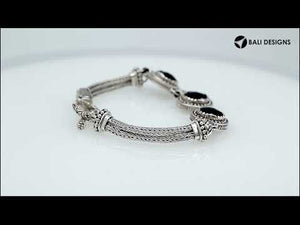 Sterling silver bracelet with Black Onyx, detailed circular motifs, multi-strand braided chains, and a decorative toggle clasp.