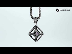 A handcrafted sterling silver pendant featuring a golden Citrine Quartz in an ornate Balinese filigree frame, showcasing fine silver artistry and elegance.