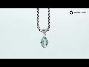 Sterling silver pear-shaped pendant featuring a faceted Blue Topaz Quartz centerpiece with polished prong-setting and intricate Balinese carved detailing.