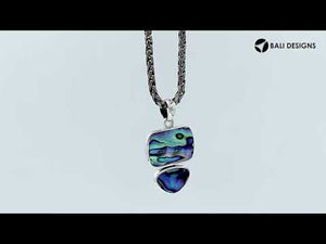 Sterling silver pendant featuring double Turquoise Shell stones with a polished surface and detailed Balinese craftsmanship.