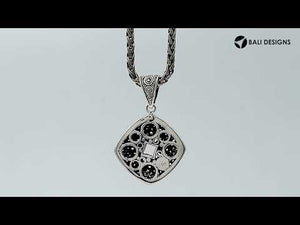 Sterling silver diamond-shaped pendant featuring circular dot engravings, geometric Balinese detailing, and polished oxidized finish.