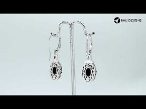 Wholesale sterling silver earrings featuring a bold Black Onyx drop accented with a bright Blue Topaz Quartz teardrop and detailed carved borders for premium catalog presentation.