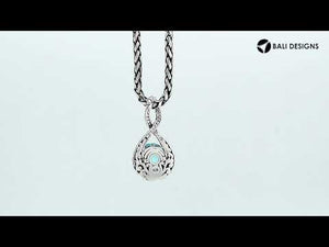Sterling silver twisted loop pendant featuring a faceted Blue Topaz Quartz center with detailed Balinese engraving and polished round artistic setting.