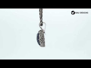 Sterling silver oval pendant featuring faceted Sapphire Quartz with Balinese floral engraving.