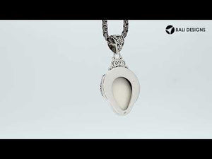 Wholesale sterling silver pendant with hand-carved bone face and peridot gemstones, Bali artisan jewelry in bulk.