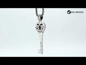 Wholesale sterling silver heart key pendant with genuine blue topaz gemstone and Balinese scrollwork, handcrafted artisan jewelry for bulk orders.