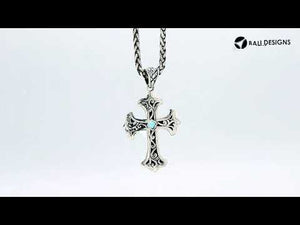 Sterling silver cross pendant with faceted peridot gemstone and Balinese textured silver design, wholesale artisan jewelry.