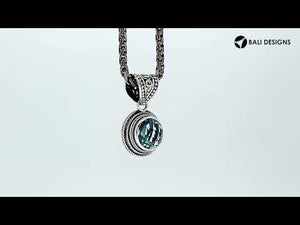 Wholesale sterling silver pendant with round Blue Topaz Quartz and ornate Balinese bail.