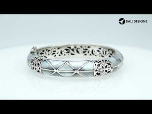 Sterling silver hinged bangle with mother of pearl inlay and intricate filigree design handcrafted in Bali.