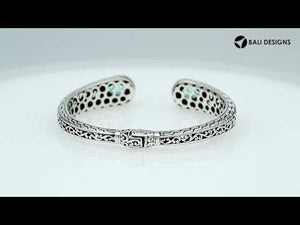 Sterling silver bangle featuring teardrop amethyst quartz stones, detailed Bali engraving, oxidized texture, and a secure hinge lock designed for premium wholesale jewelry collections.