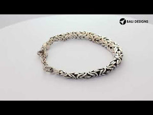 Wholesale sterling silver bracelet featuring a bold 7MM x 9MM braided chain with polished and oxidized details and a secure toggle lock for catalog-ready presentation.