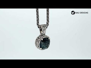 Sterling silver cushion pendant featuring Labradorite set in a carved Balinese frame with a polished high-gloss finish.