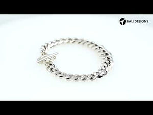 Sterling Silver curb chain bracelet featuring a smooth toggle lock and polished high-gloss surface, crafted to provide durable structure for premium wholesale presentation.