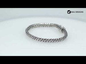 A wholesale sterling silver compact woven bracelet with an etched push clasp, featuring polished and oxidized detailing crafted for high-quality bulk jewelry collections.