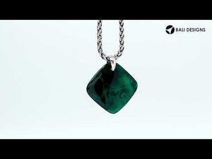 Sterling silver palm tree pendant on turquoise diamond-shaped base, handmade in Bali for wholesale jewelry buyers.