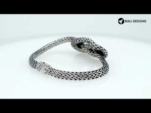 Wholesale sterling silver woven knot bracelet featuring detailed chainwork, oxidized highlights, and a secure push clasp, ideal for premium handcrafted jewelry assortments and boutique suppliers.