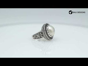 Sterling silver handcrafted Bali ring with Mother of Pearl cabochon and beaded halo design.