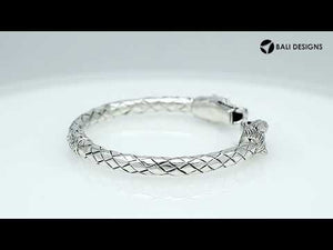 Wholesale sterling silver dragon head cuff bangle featuring detailed carvings, textured patterning, and a secure hinge-lock mechanism designed for reliable and consistent bulk inventory.