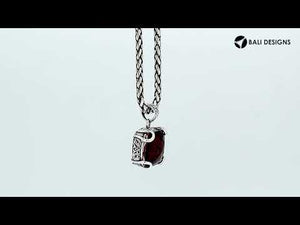 Sterling silver cushion pendant featuring a deep-toned Red Garnet Quartz center secured with artistic prong detailing and traditional Balinese carved accents.
