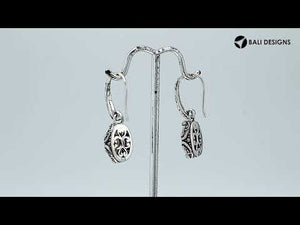Wholesale sterling silver earrings with oval Citrine Quartz set in ornate scroll-accent frames.