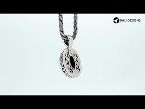 Sterling silver oval pendant featuring faceted Amethyst Quartz with detailed artisan metalwork.