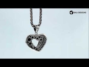 Sterling silver heart-shaped pendant featuring layered open-heart design, dotted Balinese pattern, and oxidized polished finish.