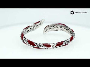 Wholesale sterling silver feather-inspired bangle featuring bold Red Coral inlays, ornate Balinese scroll engravings, and a secure hinge lock for premium artisan-style jewelry assortments.