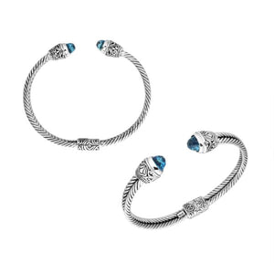 Sterling silver wholesale bangle with twisted rope design, accented by Blue Topaz Quartz and Balinese handcrafted motifs.