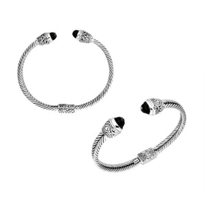 Sterling silver wholesale bangle with twisted rope design, finished with Black Onyx end caps and Balinese detailing.