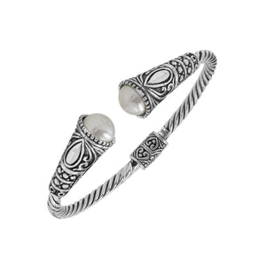 Sterling silver twisted bangle with pearl ends and oxidized Balinese design