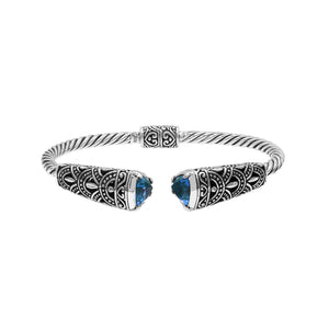 Sterling silver twisted bangle with blue topaz quartz ends and oxidized Balinese design