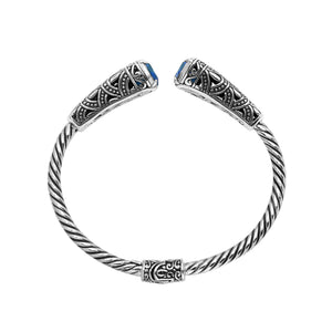 Sterling silver twisted bangle with blue topaz quartz ends and oxidized Balinese design