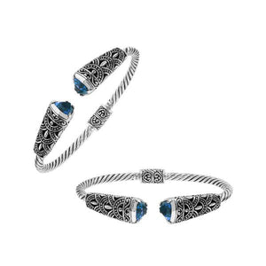 Sterling silver twisted bangle with blue topaz quartz ends and oxidized Balinese design