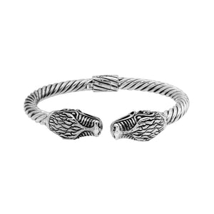 Sterling silver twisted bangle with dragon face design and oxidized Balinese pattern