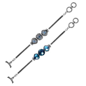 Wholesale sterling silver bracelet featuring three bright Blue Topaz Quartz stones framed in detailed Balinese settings with woven chain segments and a secure toggle lock.