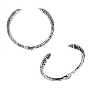 Wholesale sterling silver cuff bangle featuring detailed Balinese engravings, an oxidized antique finish, a smooth hinge lock, and a bold carved design ideal for catalog display.