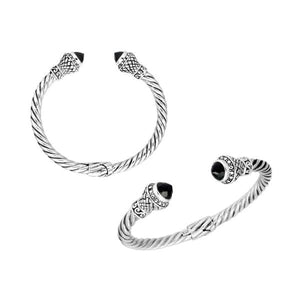 Sterling silver twisted cuff bracelet with Black Onyx caps and detailed oxidized Balinese motifs.