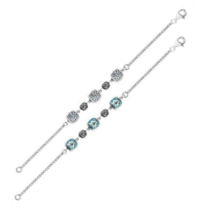 Wholesale sterling silver bracelet with blue topaz quartz stones and alternating Bali filigree links.