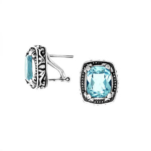 Wholesale sterling silver cushion-style earrings with Blue Topaz Quartz and handcrafted detailing.