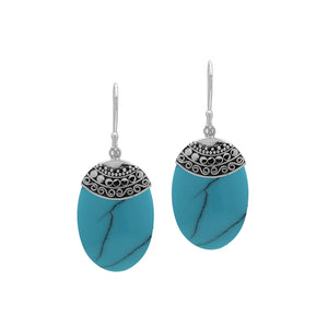 Wholesale sterling silver earrings with Turquoise Shell ovals and an ornate patterned silver cap.