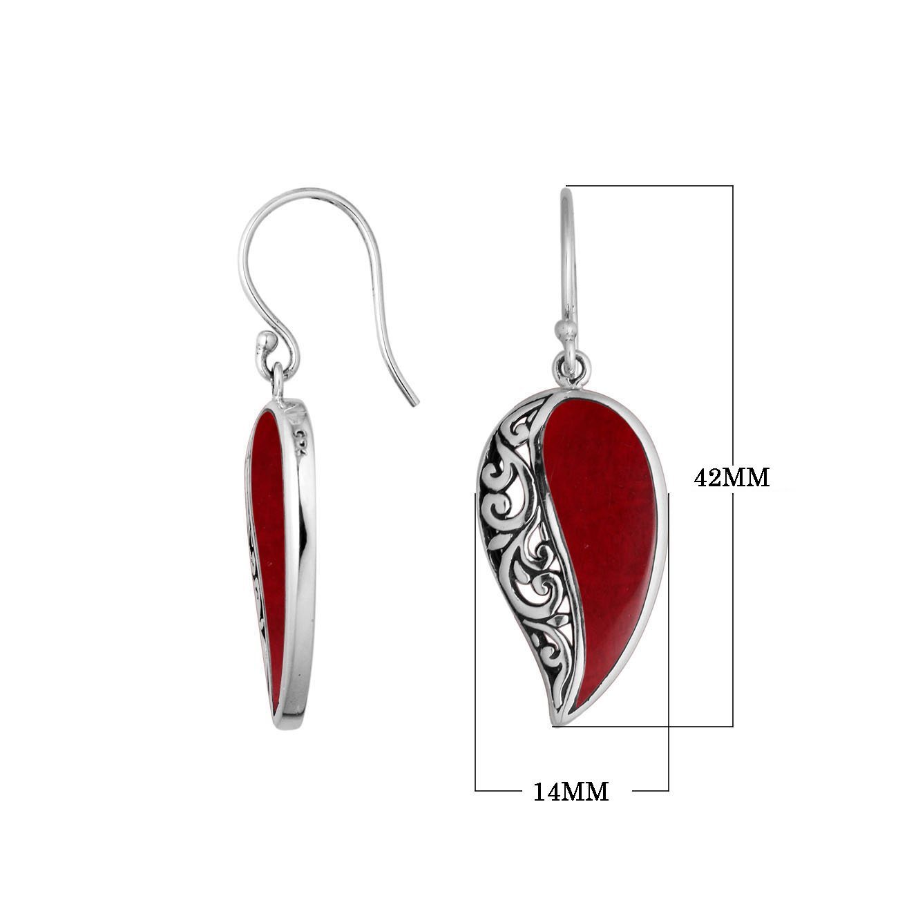 A handcrafted pair of 925 sterling silver earrings featuring teardrop-shaped Red Coral stones with Balinese filigree accents and secure earwire hooks.