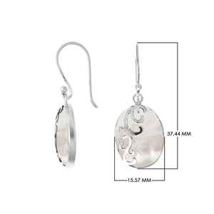 Wholesale sterling silver earrings featuring oval mother of pearl drops with polished wave-motif overlay, crafted for consistent quality, catalog readiness, and elegant presentation suitable for bulk jewelry sourcing.